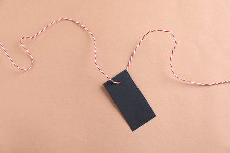 Blank tag with string on beige background, top viewの写真素材