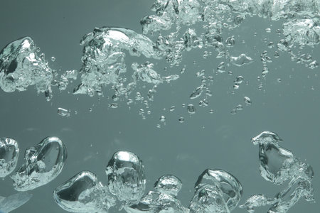 Many water bubbles on gray background, closeup
