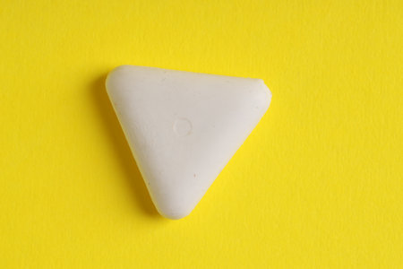 One eraser on yellow background, top viewの写真素材