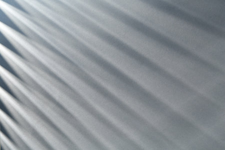 Light and shadows falling on grey background