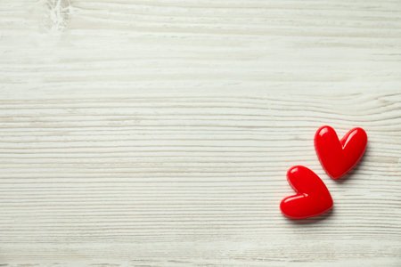 Valentine's Day. Decorative hearts on white wooden background, top view. Space for textの写真素材