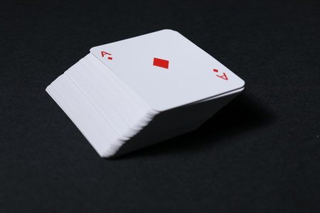 Deck of playing cards on black background, closeup