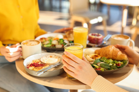 Women having tasty breakfast in cafe, closeupの写真素材