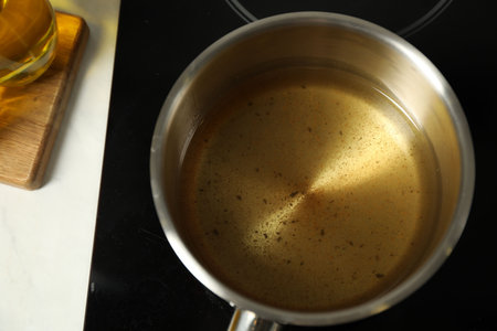 Used cooking oil in saute pan on stove, above viewの写真素材