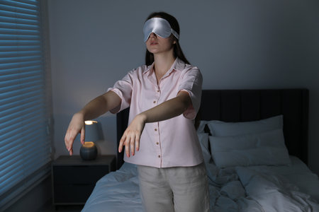 Young woman suffering from sleepwalking at homeの写真素材