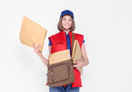 Happy postwoman with bag and envelopes on white background