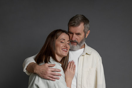 Father hugging his daughter on dark background