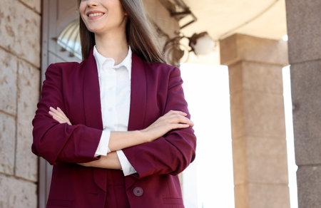 Young woman wearing stylish suit outdoors, closeup. Space for textの写真素材