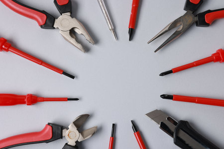 Frame of different electrical tools on grey background, flat lay. Space for textの写真素材