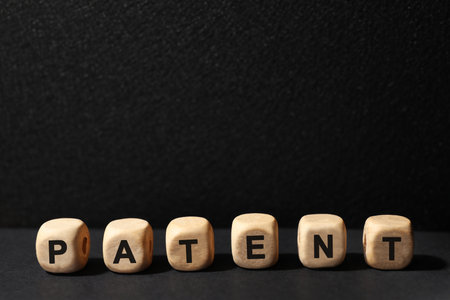 Word made of wooden cubes with letters on black table