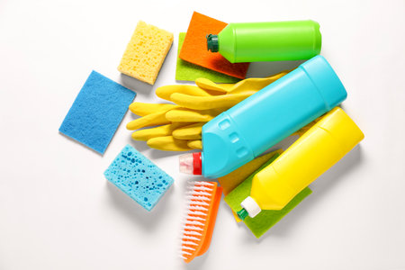 Different cleaning products and tools on white background, flat layの写真素材