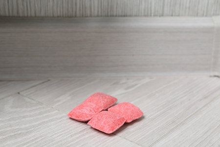 Pink objects on floor indoors, closeup. Space for text