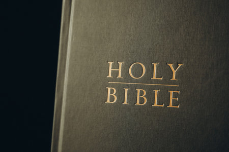 Hardcover Holy Bible on black background, closeupの写真素材