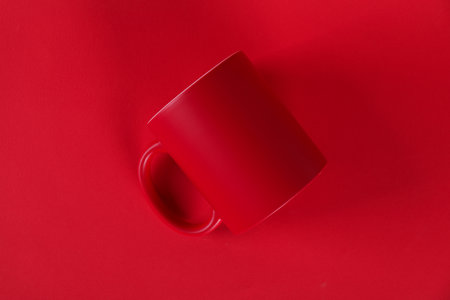 One blank mug on red background, top view. Mockup for designの写真素材