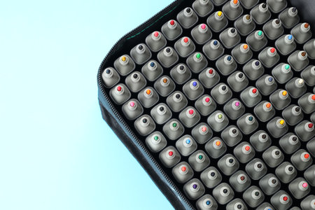 Many colorful markers in bag on light blue background, top view. Space for textの写真素材