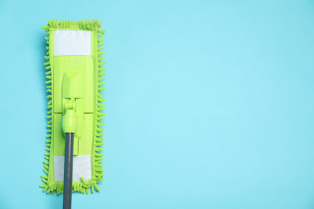 Microfiber mop on light blue background, top view. Space for textの写真素材
