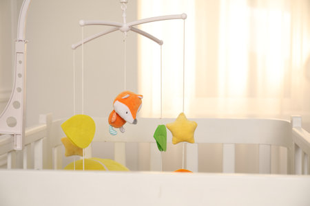 Crib with baby mobile in child's room