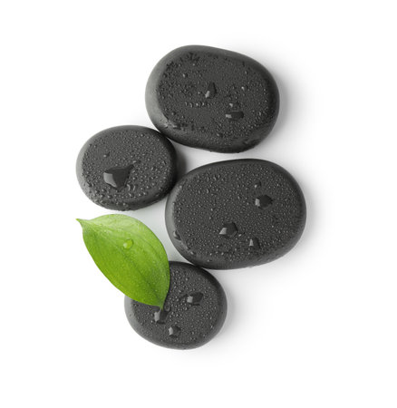Wet spa stones and green leaf isolated on white, top viewの写真素材