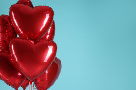 Many red heart-shaped balloons on light blue background, space for text. Happy Valentine's Dayの写真素材