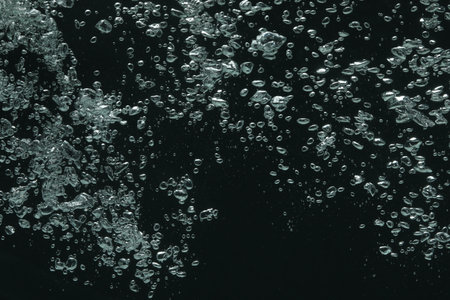 Many water bubbles on black background, closeup