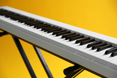 Synthesizer on yellow background, closeup. Electronic musical instrumentの写真素材