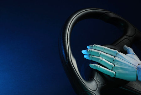 Artificial intelligence. Robot hand with steering wheel on dark blue background, closeup. Space for textの写真素材
