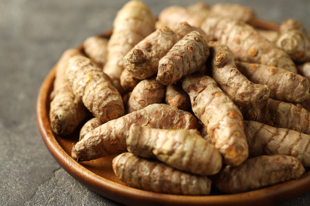 Raw tumeric rhizomes on gray table, closeupの写真素材