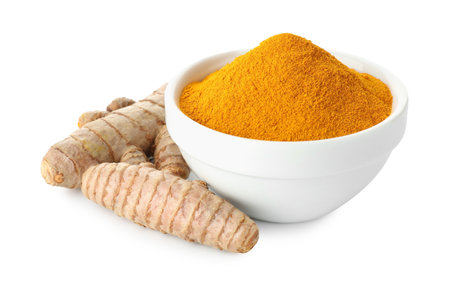 Turmeric powder in bowl and roots isolated on whiteの写真素材