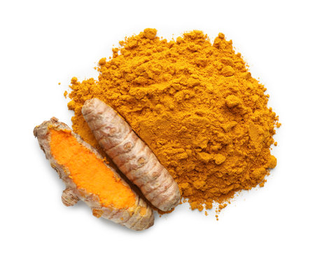 Pile of turmeric powder and roots isolated on white, top viewの写真素材