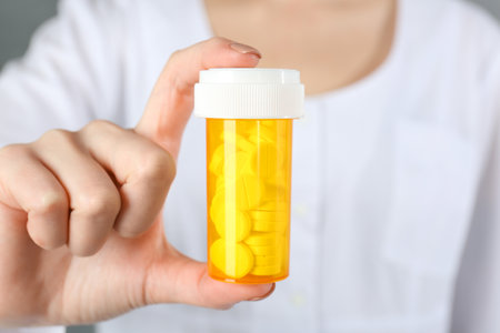 Doctor holding medical bottle of antibiotic pills, closeupの写真素材