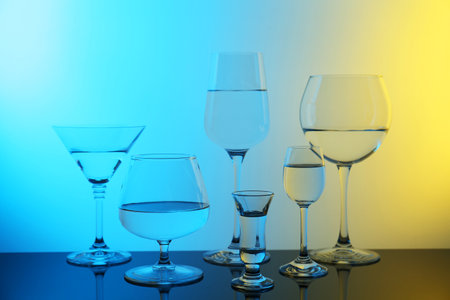 Different glasses with water on table, color tone effectの写真素材