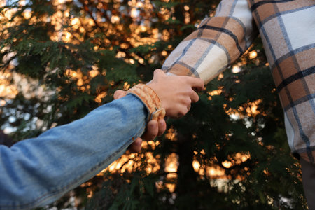 Help and support. People holding hands outdoors, closeup