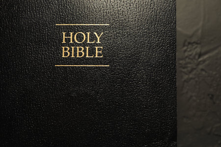 Hardcover Holy Bible in English language on black table, top viewのeditorial素材