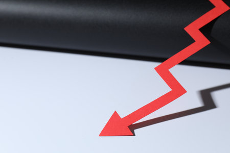 One red paper arrow on color background, closeup. Space for textの写真素材
