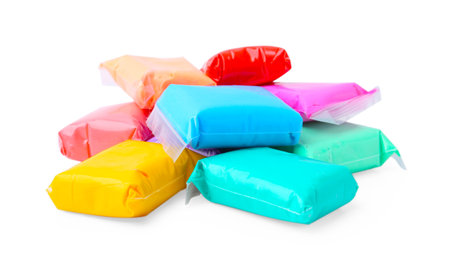 Different colorful play dough in packages isolated on whiteの写真素材