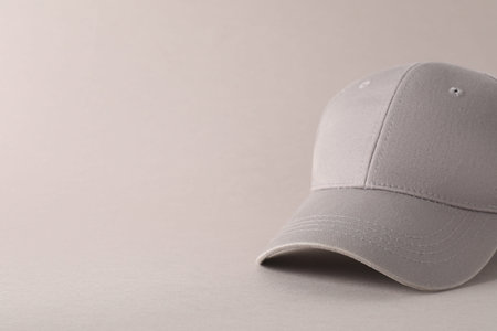 Stylish baseball cap on light gray background, closeup. Mockup for design