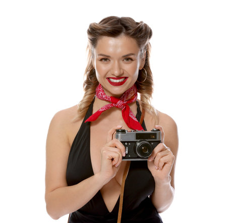Happy pin-up woman with vintage camera on white background
