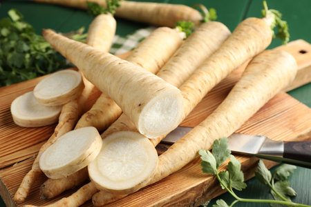 Parsley roots and leaves with knife on green wooden table, closeupの写真素材