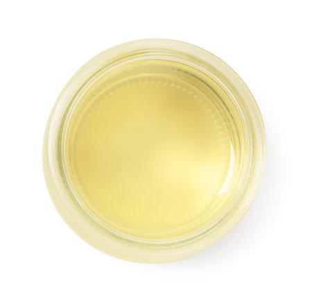 Organic coconut cooking oil in glass jar isolated on white, top viewの写真素材