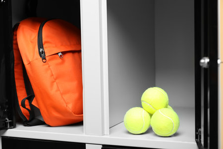 Open lockers with backpack and tennis balls, closeupの写真素材