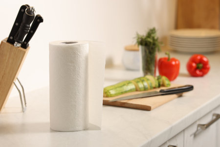Roll of paper towels on white marble countertop in kitchenの写真素材