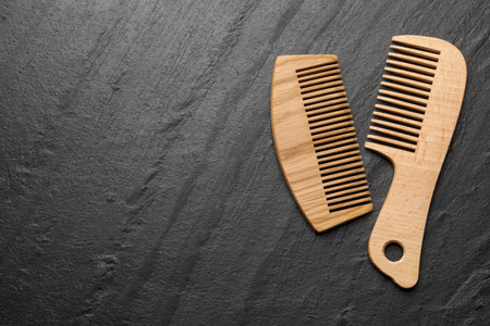 Different wooden hair combs on gray background, top view. Space for textの写真素材