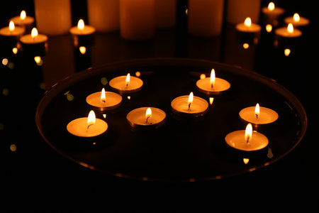 Group of burning candles on dark surfaceの写真素材