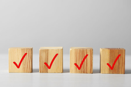 Wooden cubes with check marks on light table