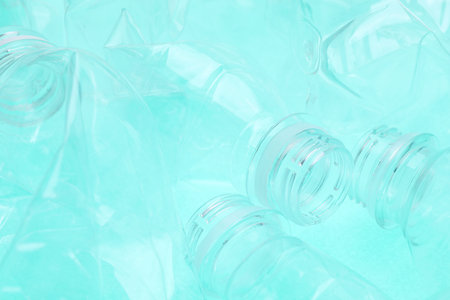 Crumpled plastic bottles on turquoise background, closeupの写真素材