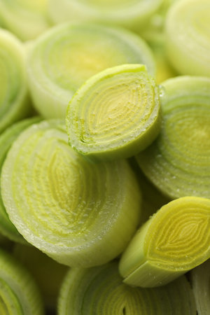 Chopped fresh leek as background, closeup view