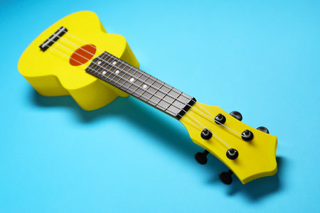 One ukulele on light blue background, closeup. String musical instrumentの写真素材