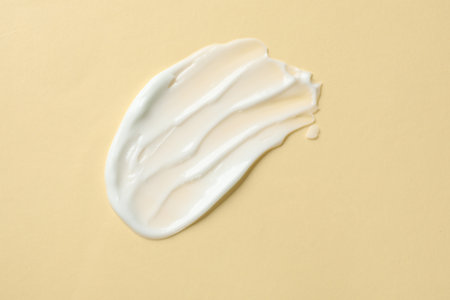 Sample of body cream on beige background, top viewの写真素材