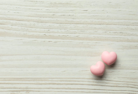 Valentine's Day. Decorative hearts on white wooden background, top view. Space for textの写真素材