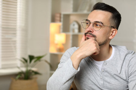 Portrait of handsome middle aged man indoors, space for text